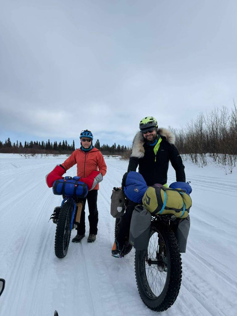 Ned Rozell, left, and Forest Wagner of Fairbanks push their bikes on the Unalakleet River just outside the village of the same name. (Photo by Warren Katchatag)