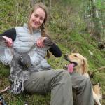 The author and her dog, Fen, with a sooty grouse in Southeast Alaska. (Photo by Bjorn Dihle)