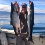 Nils Dihle with a couple of coho salmon caught in August 2025. (Photo by Mary Catharine Martin/SalmonState)