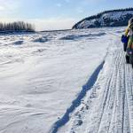Forest Wagner rides his fat bike near Bishop Rock, right, a pinch point on the flow of the Yukon River, on April 5, 2026.