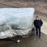 Photos by Ned Rozell
Eagle resident Steve Hamilton stands next to a block of Yukon River ice that the river lifted onto a road there on May 12, 2023.