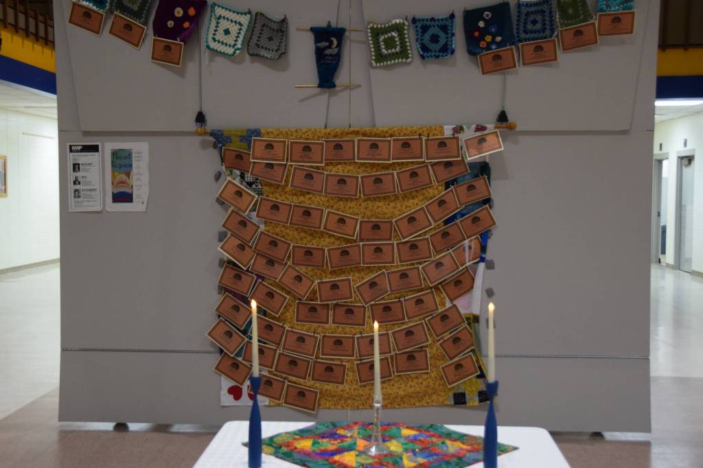 A memory wall with memorial dedication certificates made in partnership with Pier One Theatre is displayed in the Homer High School commons during the performance of the Mozart Requiem on Friday, May 1, 2026, in Homer, Alaska. (Delcenia Cosman/Homer News)
