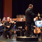 Homer High School choir director Kyle Schneider conducts the Mozart Requiem on the Homer High School Mariner Theatre stage on Friday, May 1, 2026, in Homer, Alaska. (Delcenia Cosman/Homer News)