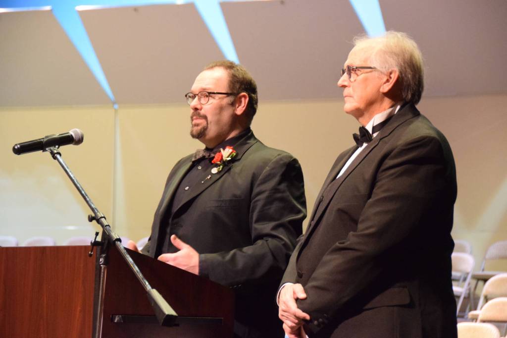 Homer High School choir director Kyle Schneider (left) and retired choir director Mark Robinson (right) give a pre-concert lecture on the Mozart Requiem on Friday, May 1, 2026, in the Homer High School Mariner Theatre in Homer, Alaska. (Delcenia Cosman/Homer News)