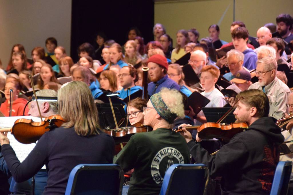Members of the community orchestra rehearse the Mozart Requiem alongside the vocal ensemble on Thursday, April 30, 2026, on the Homer High School Mariner Theatre stage in Homer, Alaska. (Delcenia Cosman/Homer News)