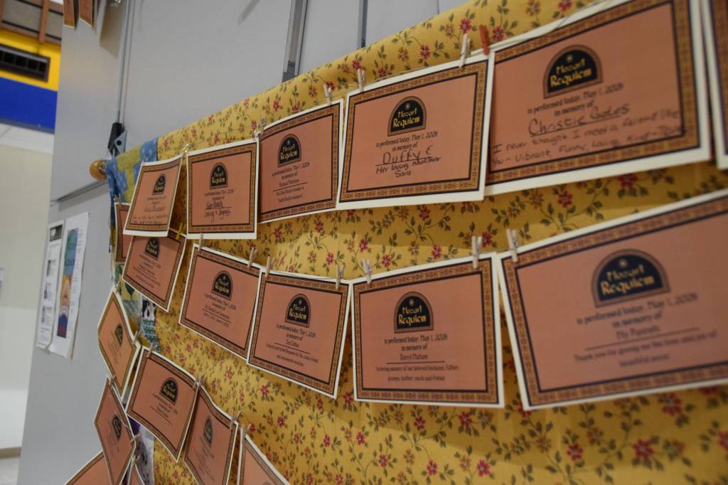 Memorial certificates are displayed on a memory wall in the Homer High School Commons as part of the Mozart Requiem performance on Friday, May 1, 2026, in Homer, Alaska. (Delcenia Cosman/Homer News)