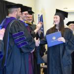 University of Alaska Fairbanks graduate Emily Ault (right) shakes hands with UA Regent Joe Crum during a commencement ceremony held Wednesday, May 6<ins>, 2026,</ins> at Kachemak Bay Campus<ins> in Homer, Alaska</ins>. (Delcenia Cosman/Homer News)