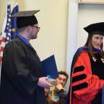 Kachemak Bay Campus associate professor Lia Calhoun (right) presents Erick Paulsrud (left) with the KBC Staff and Faculty Choice Award during a commencement ceremony held Wednesday, May 6<ins>, 2026,</ins> at Kachemak Bay Campus<ins> in Homer, Alaska</ins>. (Delcenia Cosman/Homer News)