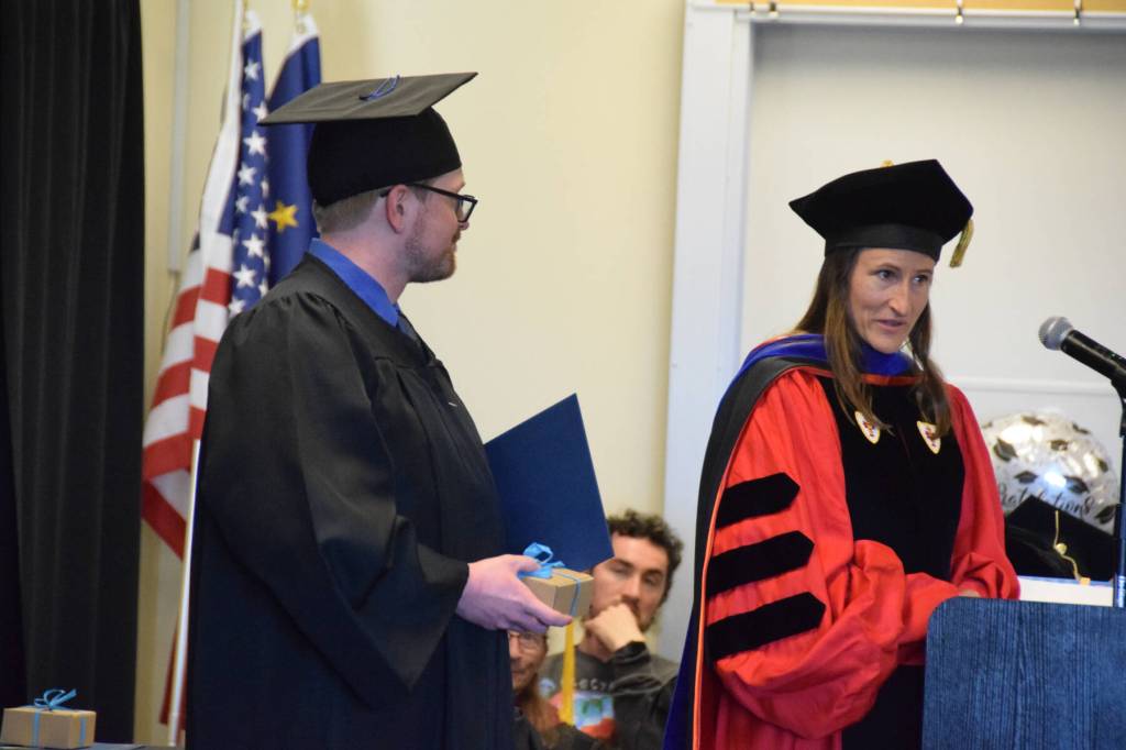 Kachemak Bay Campus associate professor Lia Calhoun (right) presents Erick Paulsrud (left) with the KBC Staff and Faculty Choice Award during a commencement ceremony held Wednesday, May 6<ins>, 2026,</ins> at Kachemak Bay Campus<ins> in Homer, Alaska</ins>. (Delcenia Cosman/Homer News)