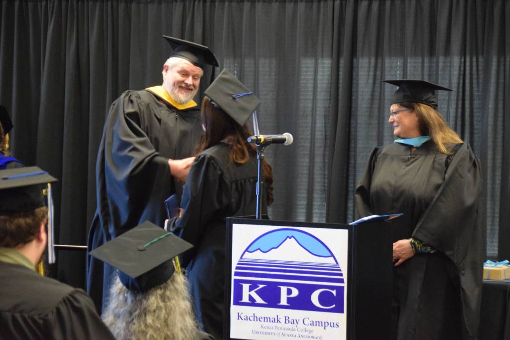 Graduates who earned their high school equivalency diplomas shake hands with Kachemak Bay Campus director Brian Partridge (left) during a commencement ceremony held Wednesday, May 6<ins>, 2026,</ins> at Kachemak Bay Campus<ins> in Homer, Alaska</ins>. (Delcenia Cosman/Homer News)