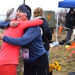 Runners give each other a congratulatory hug at the finish line of the annual Migration Run held Sunday, May 10<ins>, 2026,</ins> on the Homer Spit Trail<ins> in Homer, Alaska</ins>. (Delcenia Cosman/Homer News)