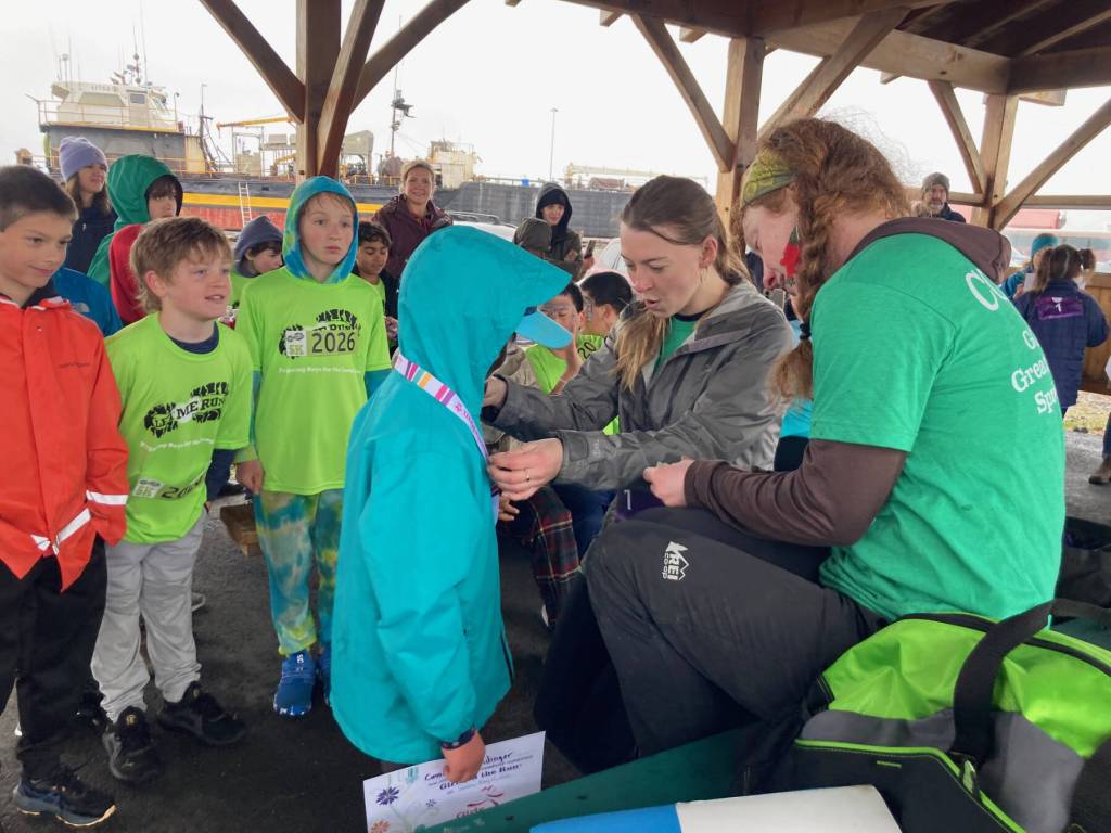 Program mentors hand out medals to Girls on the Run and Let Me Run youth participants after a celebratory 5K race on Sunday, May 10, 2026, on the Homer Spit Trail in Homer, Alaska. Photo courtesy Marcee Gray