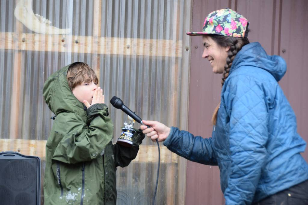 Thor, 7, from Homer (left) reenacts his snipe winnowing imitation for emcee Mallory Primm (right) and the audience gathered for the ninth annual Shorebird Festival bird calling contest on Saturday, May 9<ins>, 2026,</ins> at the Homer Brewing Company<ins> in Homer, Alaska</ins>. Thor won an award for the Serious youth category in the contest. (Delcenia Cosman/Homer News)