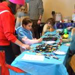 Kids draw at a free crafting table at the sixth annual Motherbird Fair on Sunday, May 10<ins>, 2026,</ins> at Lands End Resort<ins> in Homer, Alaska</ins>. (Delcenia Cosman/Homer News)