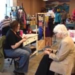 Pastor Lisa Talbott (left) and Bonita Banks (right) of Kindred Spirits Weaving Studio sell their handwoven goods at the sixth annual Motherbird Fair on Sunday<ins>, May 10, 2026,</ins> at Lands End Resort<ins> in Homer, Alaska</ins>. (Delcenia Cosman/Homer News)