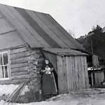 This photo, from the Alyce E. Anderson Collection, Anchorage Museum, shows Ninilchik teacher Alyce Anderson in 1911, standing in the doorway of the first Ninilchik school. A new school was built in the vicinity of the communitys Russian Orthodox Church in 1913.
