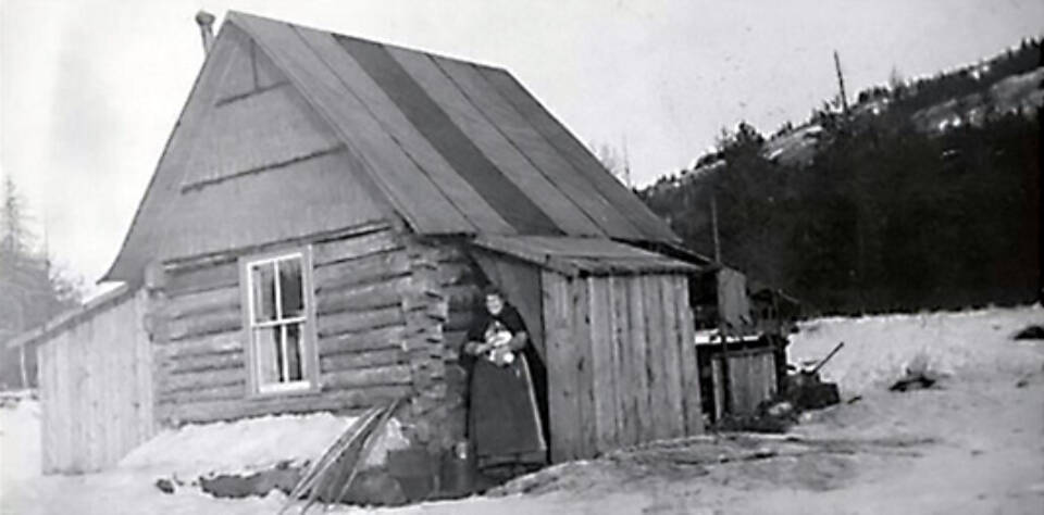 This photo, from the Alyce E. Anderson Collection, Anchorage Museum, shows Ninilchik teacher Alyce Anderson in 1911, standing in the doorway of the first Ninilchik school. A new school was built in the vicinity of the communitys Russian Orthodox Church in 1913.