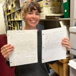 Photo by Alanna Greenwell
Geophysical Institute communications coordinator Sara Wilbur holds the original, handwritten How to win the ice pool column in the Mather Library archives.