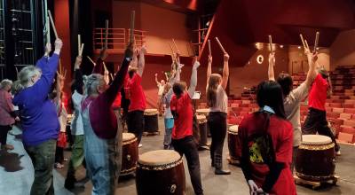 Homer community members take part in a taiko drumming workshop on May 4, 2024 at the Homer High School Mariner Theatre. The Alaska Japanese Club Homer hosts regular Japanese Taiko Drumming Group Lessons at Homer United Methodist Church. (Delcenia Cosman/Homer News file photo)