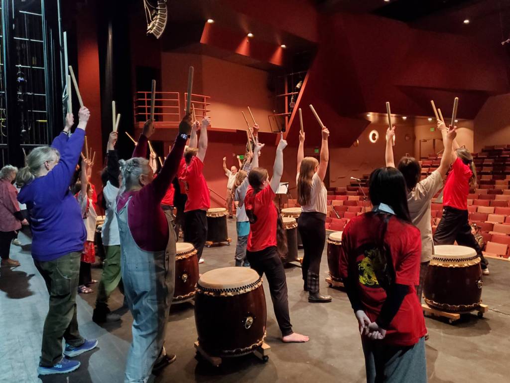 Homer community members take part in a taiko drumming workshop on May 4, 2024 at the Homer High School Mariner Theatre. The Alaska Japanese Club Homer hosts regular Japanese Taiko Drumming Group Lessons at Homer United Methodist Church. (Delcenia Cosman/Homer News file photo)