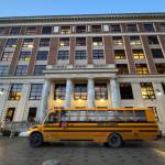 A school bus drives by the Alaska State Capitol on Jan. 21, 2026. (Photo by James Brooks/Alaska Beacon)