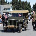 Youth, whose parents are American Legion Post 16 members, wear Second World War-era uniforms as they accompany Legion life member Bill Sheldon, driving a refurbished Second World War jeep in Homers Fourth of July parade. (Delcenia Cosman/Homer News file photo)