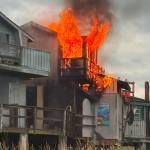 Flames shoot out of the second floor above Boardwalk Fish & Chips. (Tim Hatfield photo)